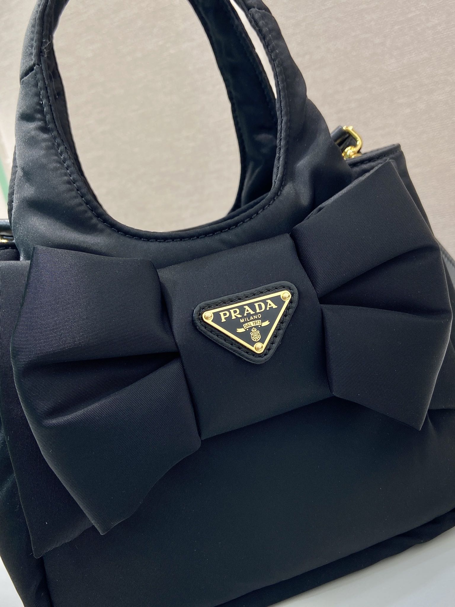 Bagsaaa Pra*a Padded Re-Nylon mini-bag with bow 1BA359 black - 18cm