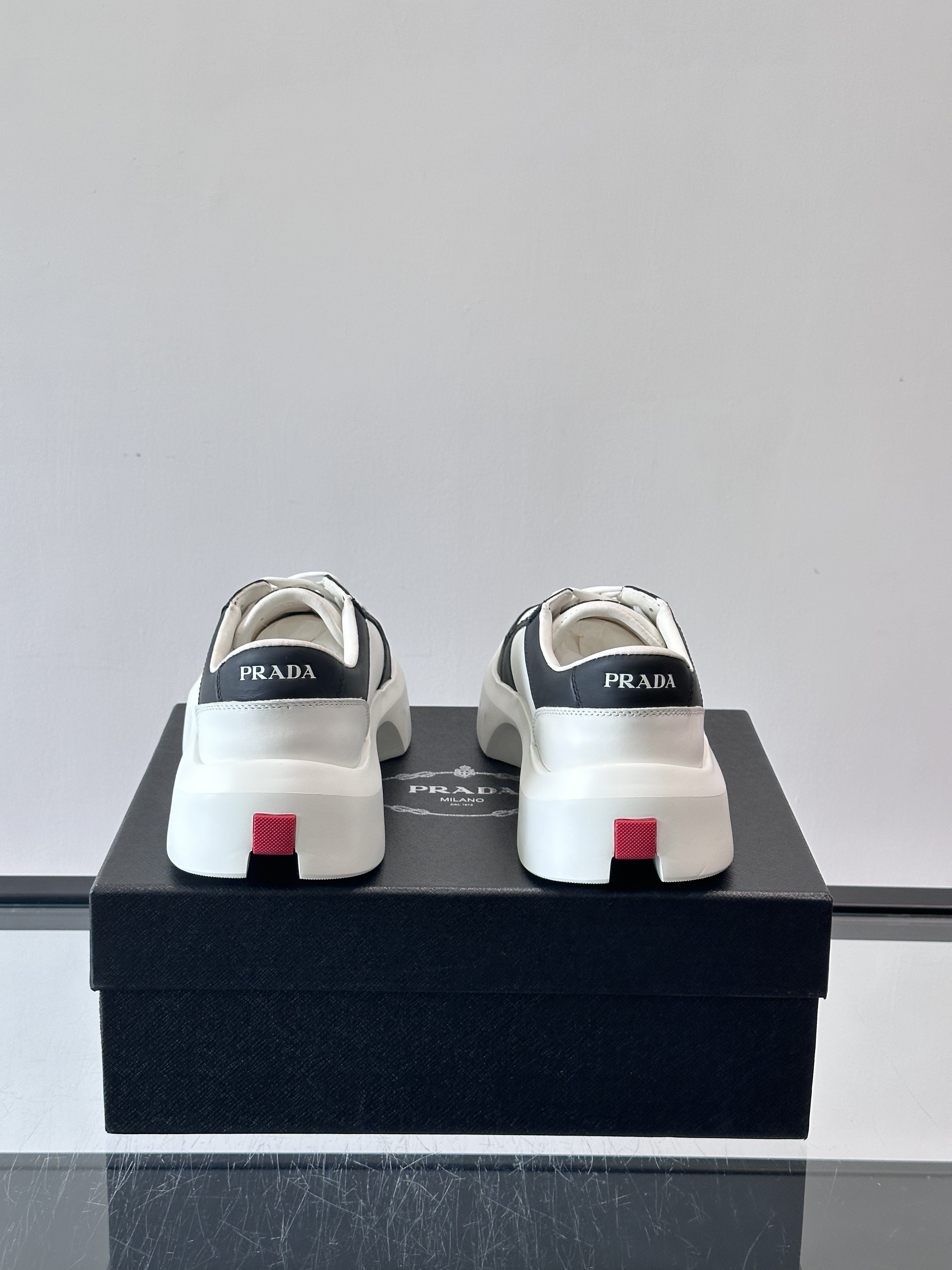 Bagsaaa Pra*a Downtown leather sneakers in a white and black colorway