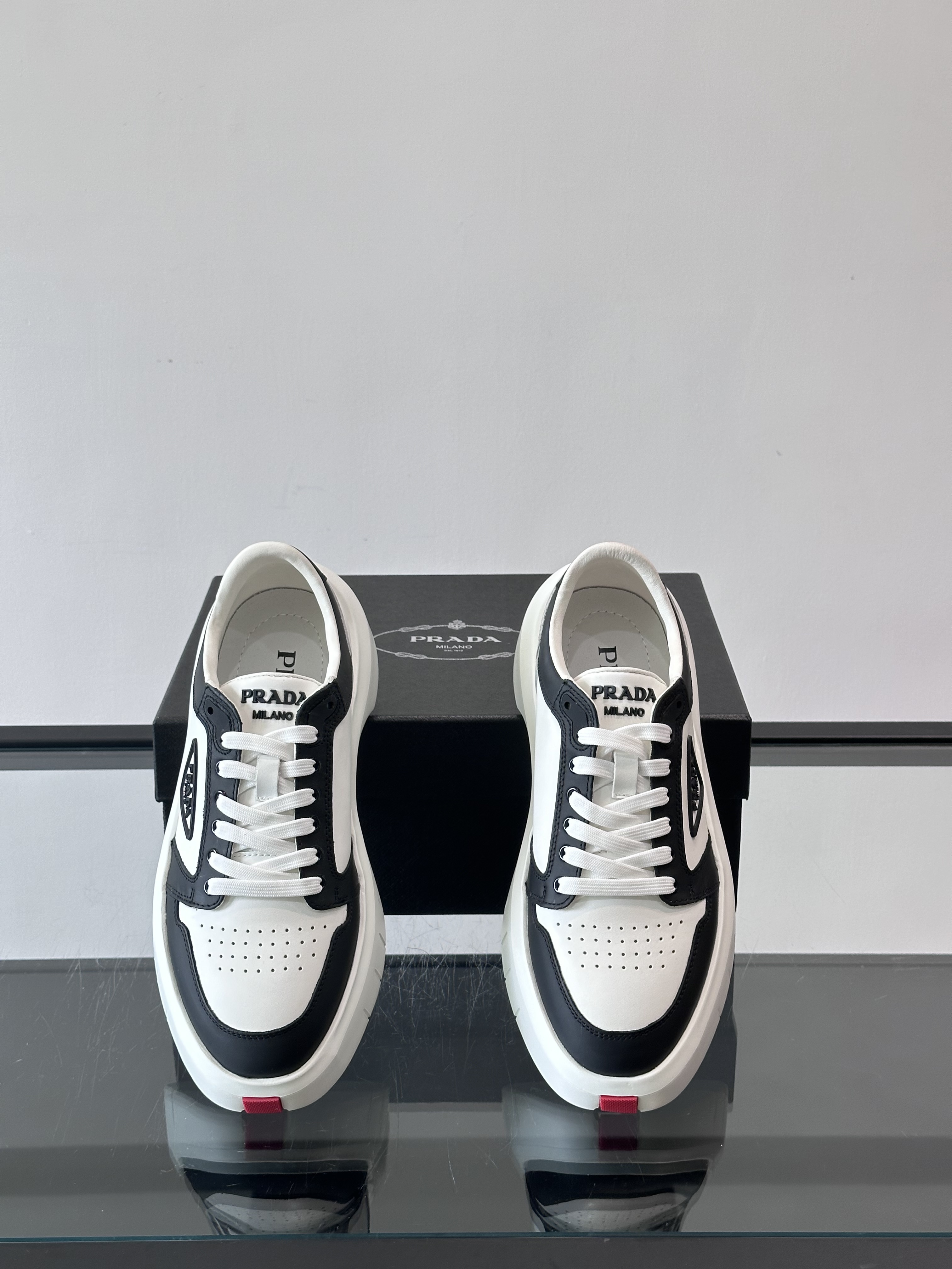 Bagsaaa Pra*a Downtown leather sneakers in a white and black colorway