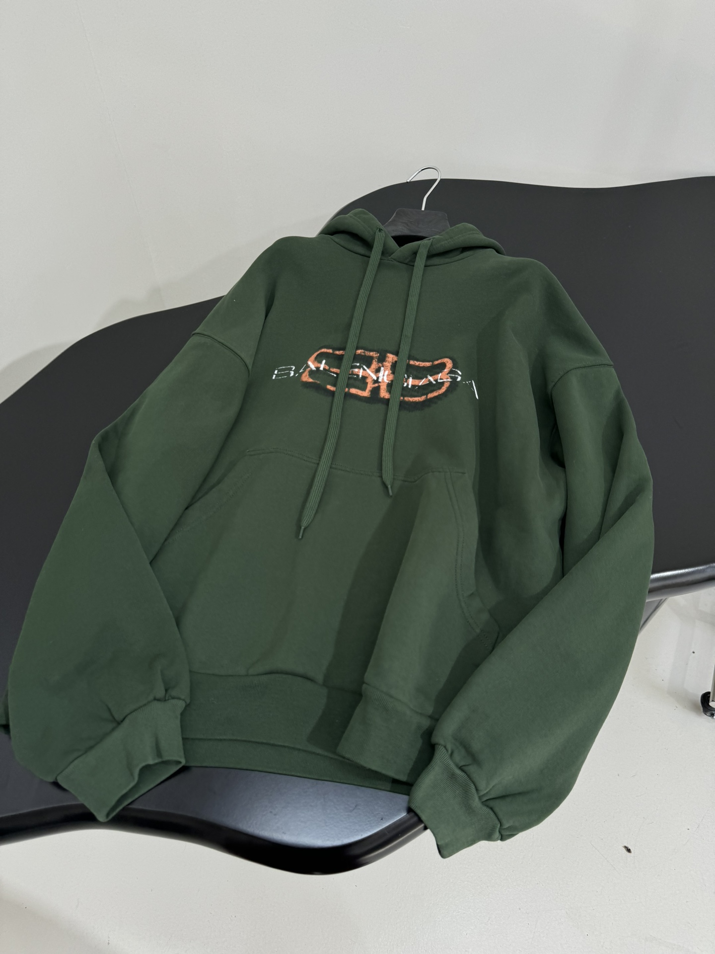 Bagsaaa Ba1en*iaga green hoodie with a shaded logo effect