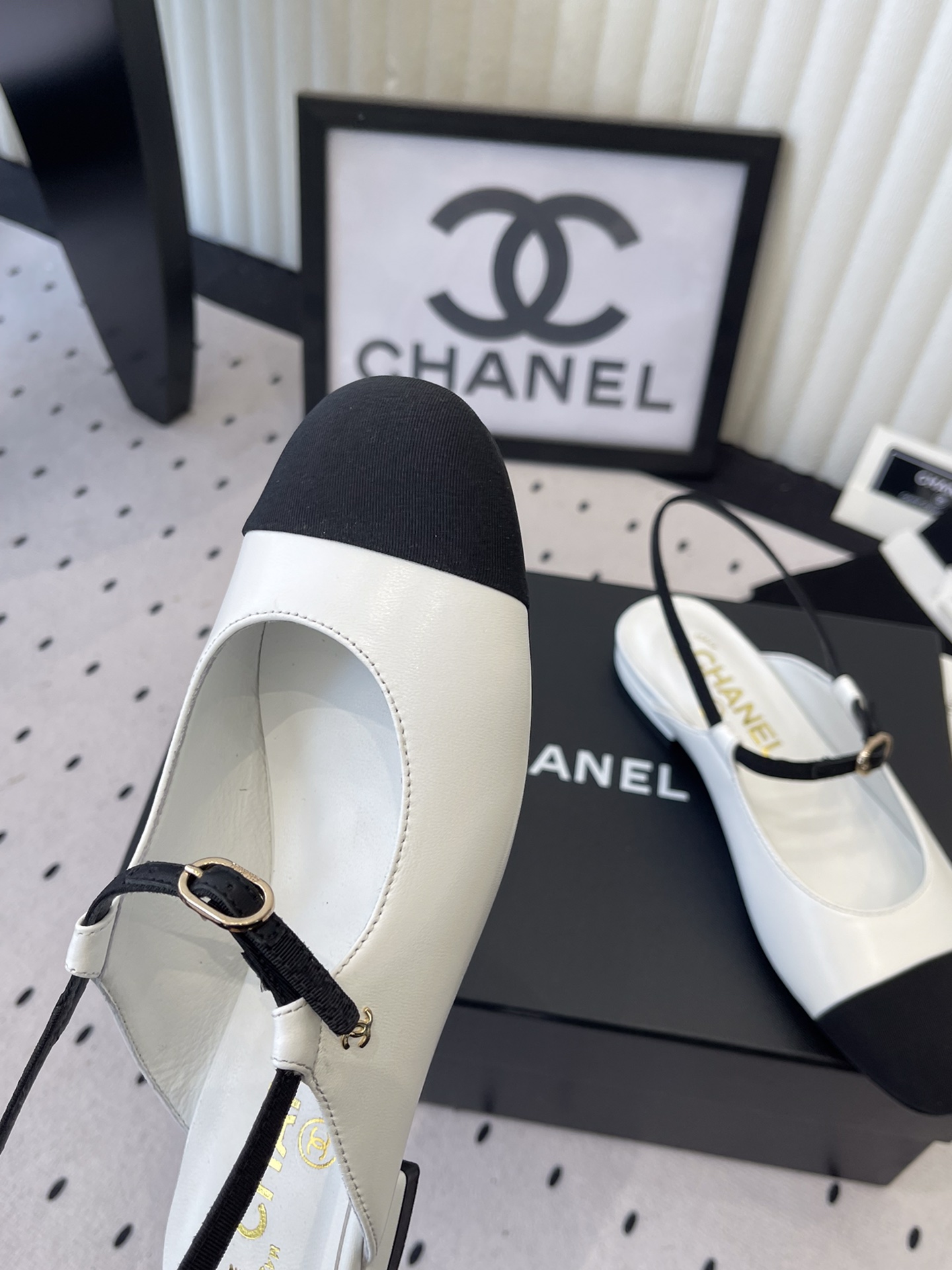 Bagsaaa Ch**el leather Mary Jane flats in white and black with an ankle strap